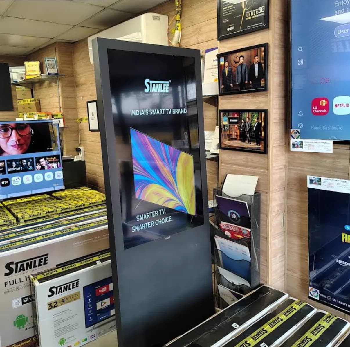 Inside the Ghaziabad store — boxed Stanlee televisions, the wall displays and the branded kiosk, photographed by the reviewer